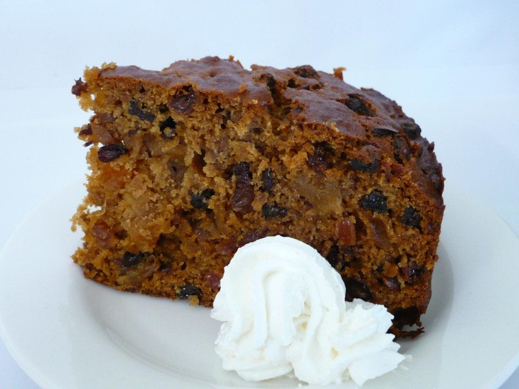 Boiled Fruit Cake on a plate with cream